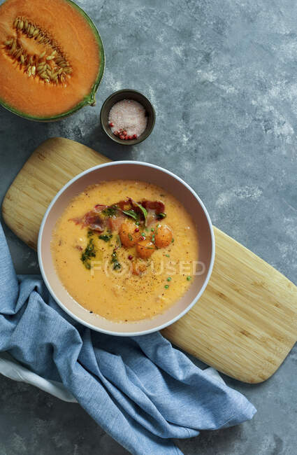 Orange melon cold soup, with jamon, typical spanish dish — Stock Photo