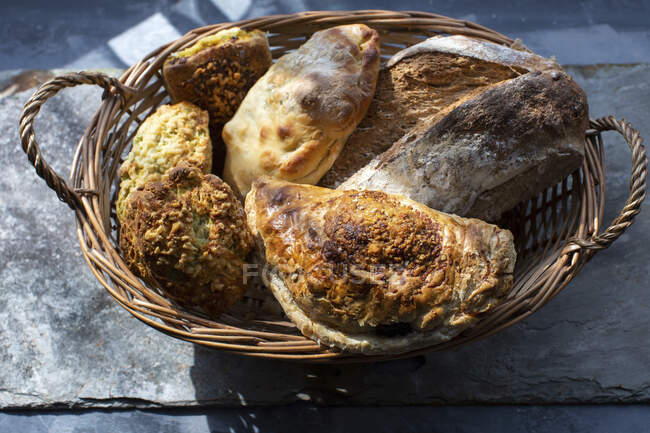 Artisan bread pastries in wicker basket — Stock Photo
