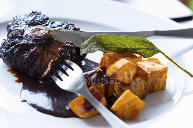 Roasted pork ribs with spices on a white plate — Stock Photo