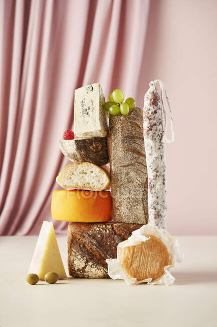 Cheese still life with salami and baguette — Stock Photo