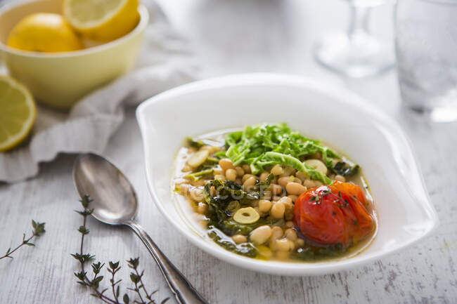 Bean soup with cabbage, tomatoes, lemons and thyme — Stock Photo