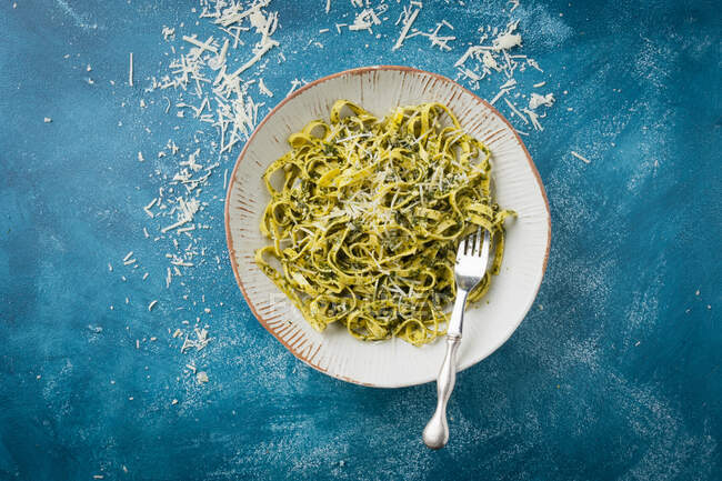 Tagliatelle with pesto and grated parmesan cheese — Stock Photo