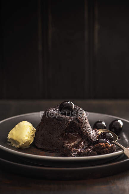 Hot chocolate fondant with amaretto cherries and clotted cream — Stock Photo