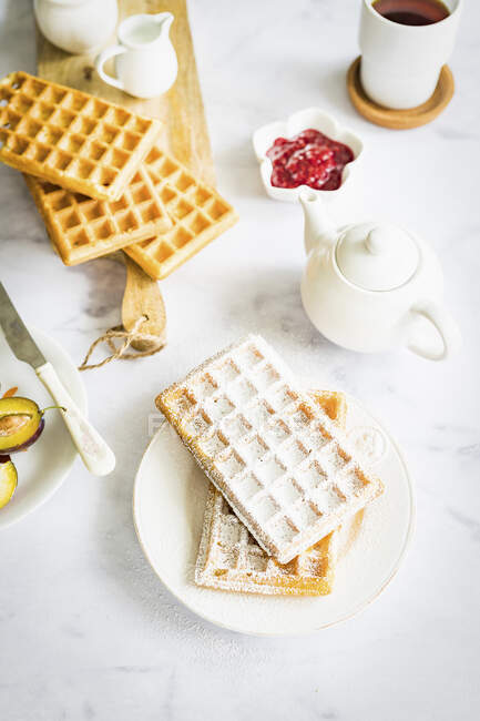 Crispy homemade waffles with icing sugar — Stock Photo