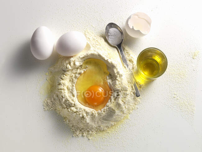 Making pasta dough on white background — Stock Photo