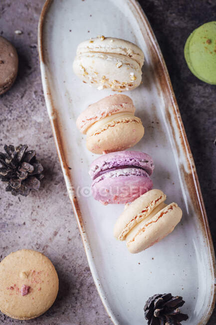 Mini macarons served on long plate — Stock Photo
