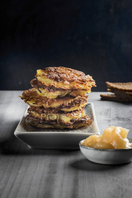 A stack of potato fritters with apple sauce — Stock Photo