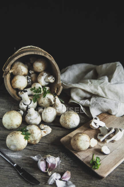 Close-up shot of delicious Mushrooms champignon on the wood table — Stock Photo