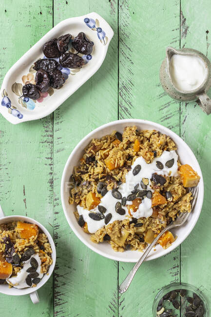 Pilaf with pumpkin, pumpkin seeds and prunes, yogurt — Stock Photo