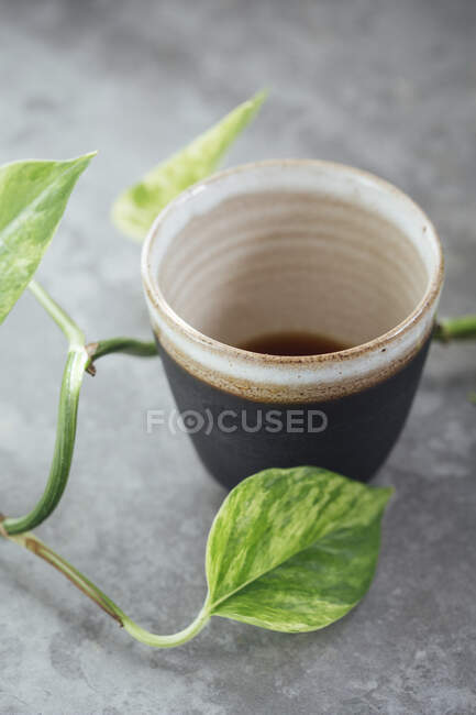 Black coffee in a handmade black clay cup — Foto stock