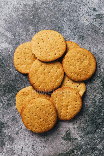Digestive biscuits on rustic stone surface — Stock Photo