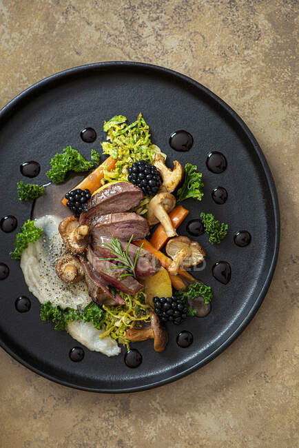 Pigeon breast with mushrooms, artichoke puree, fondant potatoes, kale and brussels sprouts with walnuts — Stock Photo
