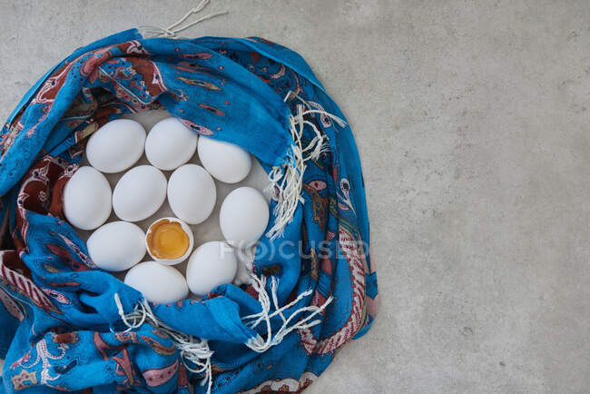 Білі яйця, загорнуті в синій шарф — стокове фото