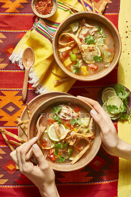 Mexican soup with tortillas and lime — Stock Photo