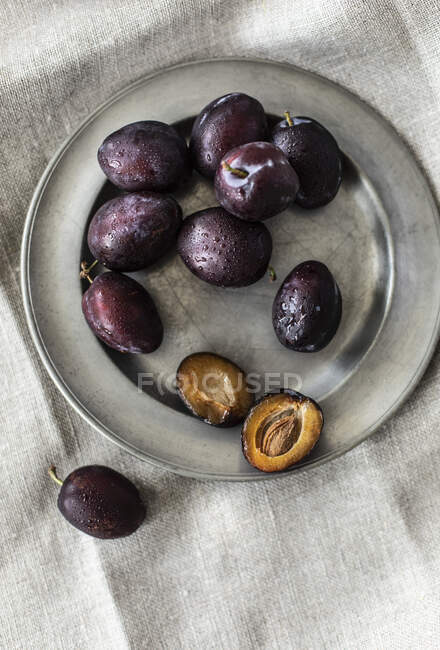 Close-up shot of delicious Plums on metal plate — Stock Photo