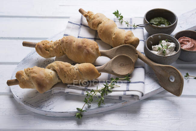 Baked bread from the oven with three vegan dips — Stock Photo