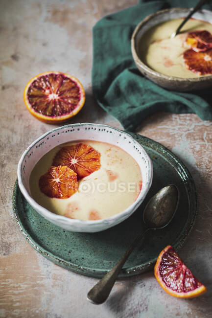 Close-up shot of delicious Pudding of millet with red oranges — Stock Photo