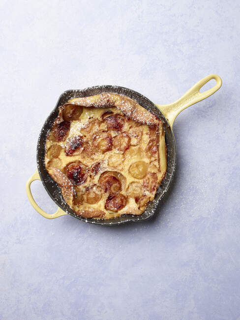 Plums clafoutis pie in pan, top view — Stock Photo