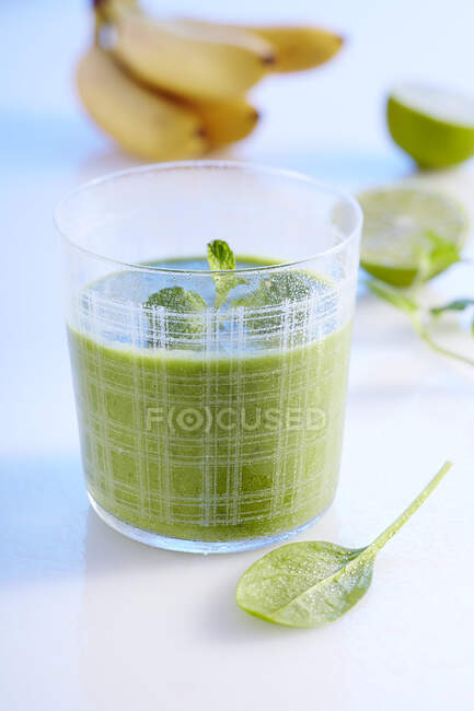 Frullato verde a base di banana, mela, spinaci, cetriolo, zenzero, lime e latte di cocco — Foto stock