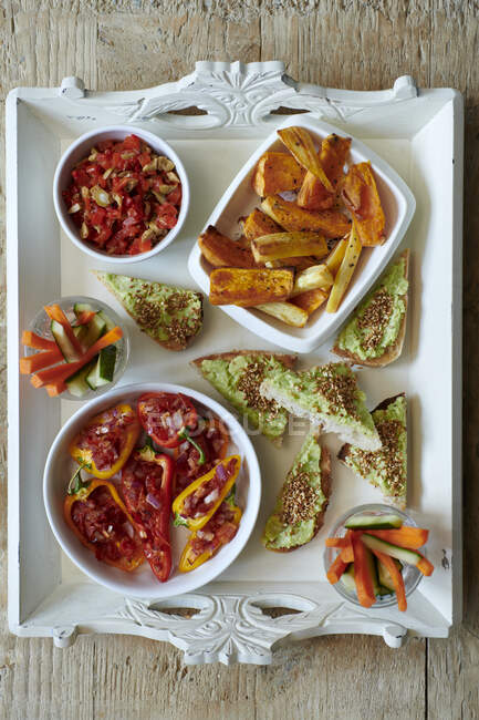 Stuffed Peppers with Avocado Toasts and Roasted Sweet Potatoes — Stock Photo