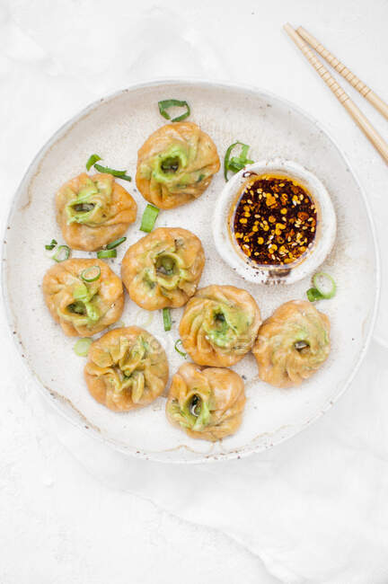 Pumpkin dumplings with vegan stuffing served with chili oil — Stock Photo