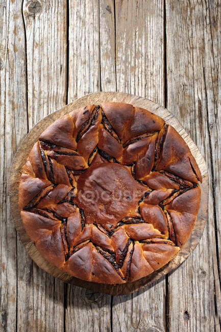 Chocolate yeast cake on a wooden plate — Stock Photo
