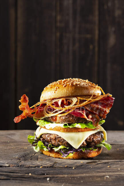 Double burger with cheese and bacon — Stock Photo