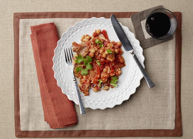 Country Style Pork Ribs With Chorizo Tomato Sauce Overhead with glass of wine — Stock Photo