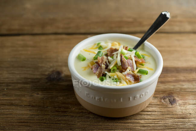 Potato cheddar soup on wood — Stock Photo
