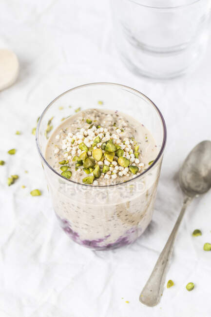 Chia pudding with blueberry compote and pistachios in a glass — Stock Photo