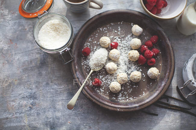 Close-up shot of delicious Coconut truffles with raspberries — Stock Photo