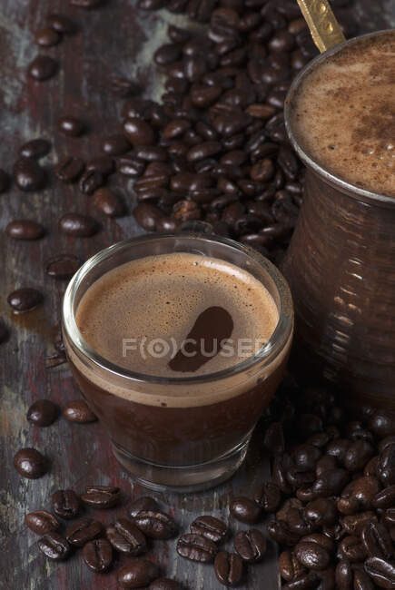 Turkish coffee in a cezve and a glass cup — Stock Photo