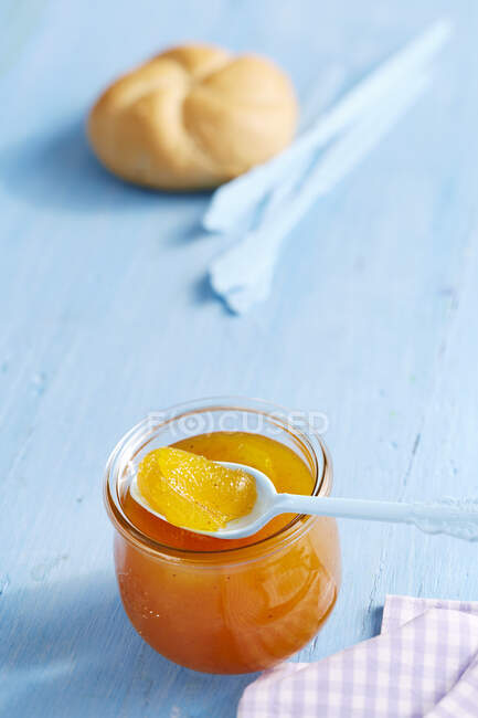 Vaso di marmellata di mango e vaniglia con panino sullo sfondo — Foto stock