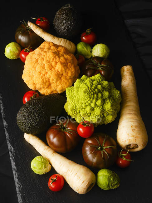 Various types of vegetables on a black surface — Stock Photo