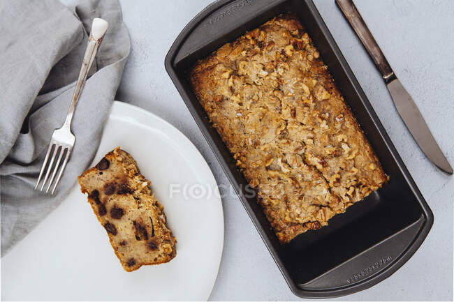 Freshly baked chocolate chip banana bread loaf topped with walnuts — Stock Photo