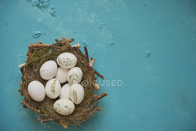 Painted Easter eggs in Easter nest — Stock Photo