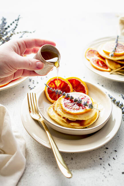Pancakes with blood oranges and honey and lavenda — Stock Photo