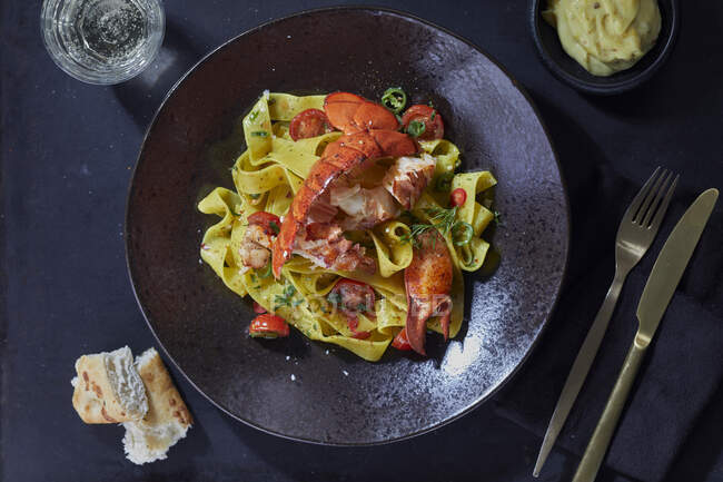 Ribbon pasta with lobster — Stock Photo