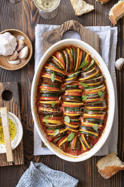 Baked ratatouille with spices and basil leaves in tin — Stock Photo