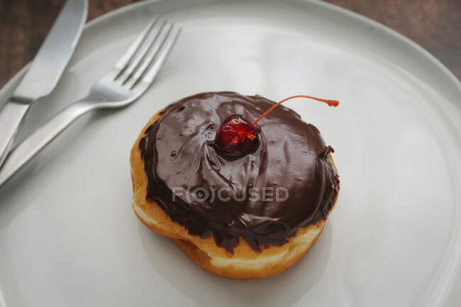 Cherry topped Boston Cream donut — Stock Photo