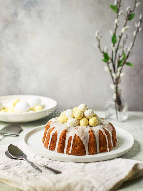 Coconut Easter cake with white chocolate eggs — Stock Photo