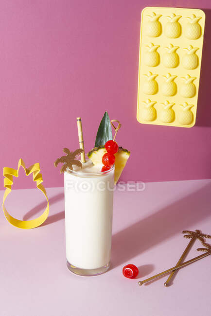 Pina colada cocktail with pineapple, cherries decorations and decorating tools — Stock Photo
