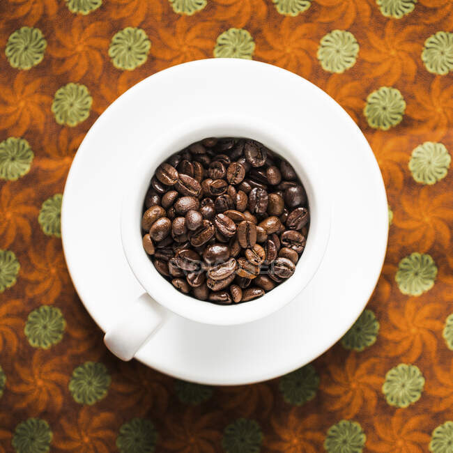 Close-up shot of Coffee Beans in a coffee cup — Stock Photo