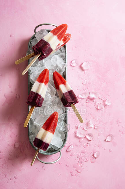 Homemade three color strawberry, banana and blueberry ice lollies — Stock Photo