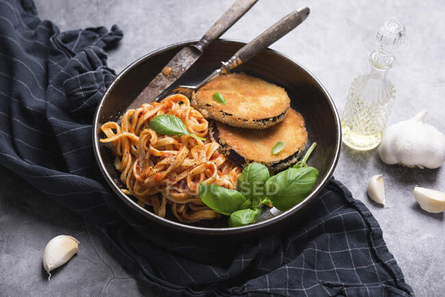 Aubergines cutlet with ribbon pasta in tomato sauce — Stock Photo