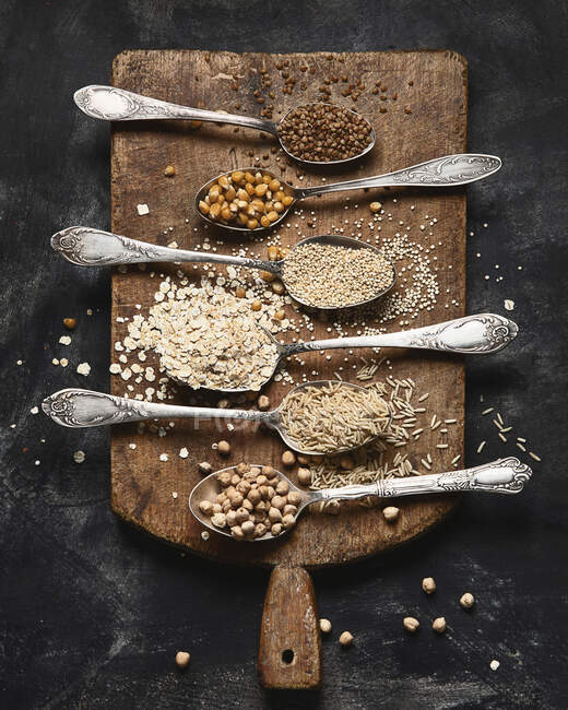 Healthy gluten free grains on rustic wooden board — Stock Photo