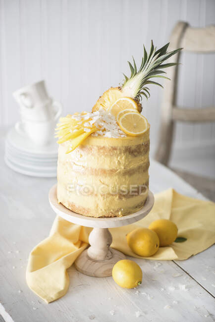A naked cake with pineapple, mango and lemons — Stock Photo