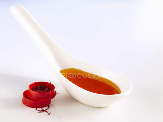 Homemade syrup with saffron, acacia honey and lime on a spoon — Stock Photo