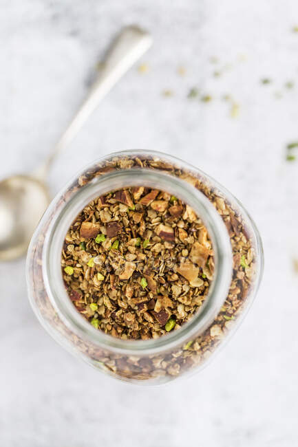 A jar of pistachio granola — Stock Photo