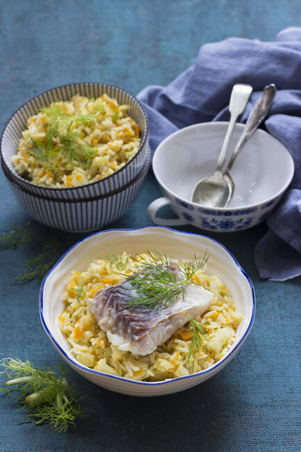 Carrot and fennel pilaf with cod and fennel leaves — Stock Photo